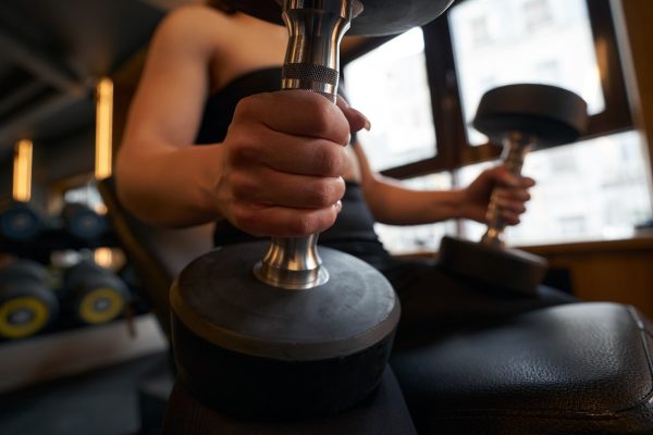 female-athlete-performing-seated-dumbbell-exercise-2025-03-07-19-37-25-utc